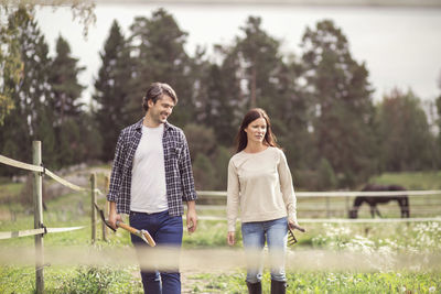 Happy mid adult couple walking in organic farm