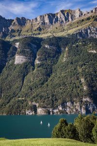 Scenic view of lake and mountains against sky