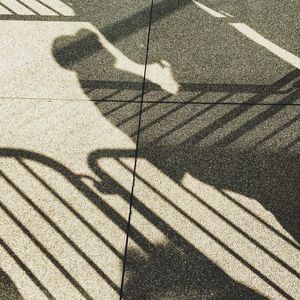 Shadow of person on road