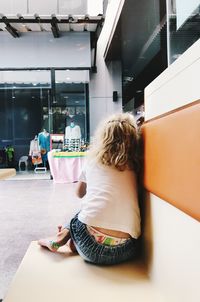 Rear view of girl sitting in cafe