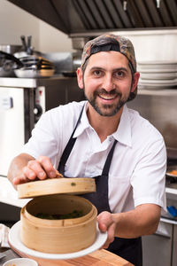 Portrait of a smiling man holding camera