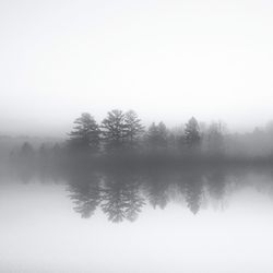 Scenic view of lake in foggy weather