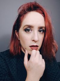 Close-up portrait of beautiful woman against white background