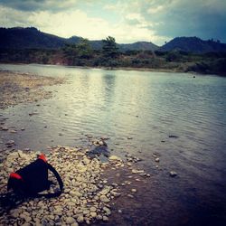 Scenic view of lake against cloudy sky