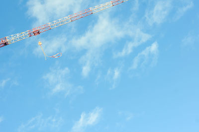 Low angle view of crane against sky