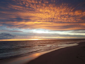 Scenic view of beach against sky during sunset