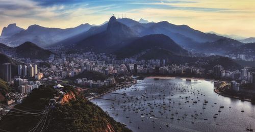 High angle view of townscape by mountains against sky