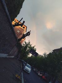 Buildings in city against sky during sunset