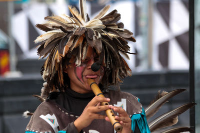 Close-up of man playing flute