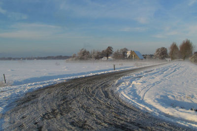 Scenic view of snow covered landscape against sky