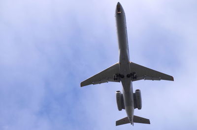 Low angle view of airplane against sky