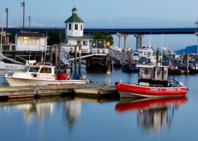 Boats moored at harbor in city