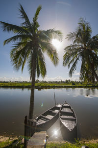 Two rowing boats parked at calm river close to hoi an