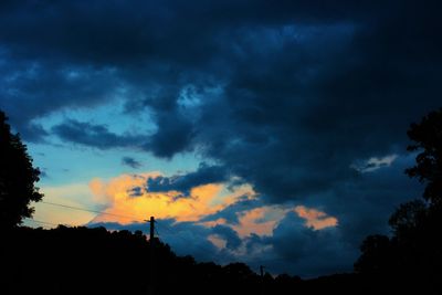 Silhouette of tree against cloudy sky