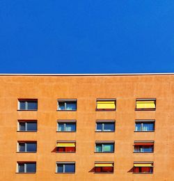 Low angle view of building against clear blue sky