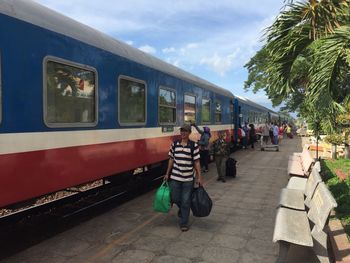 People standing on train against sky