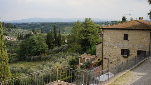 High angle view of buildings and trees against sky