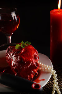 Close-up of red wine in glass on table