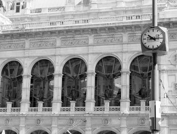 Low angle view of clock tower against building