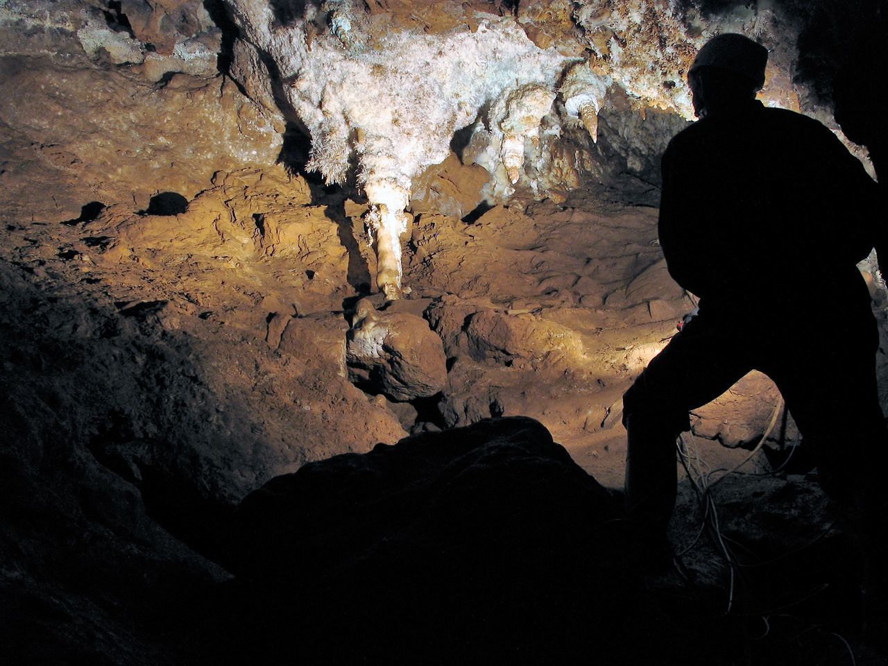 SILHOUETTE MAN STANDING ON ROCK