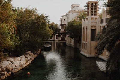 River amidst buildings against sky