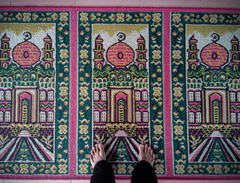 Low section of person standing on carpet