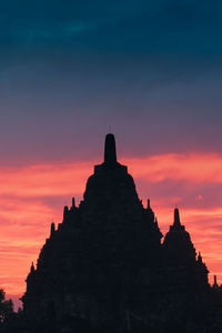 Silhouette temple against sky during sunset