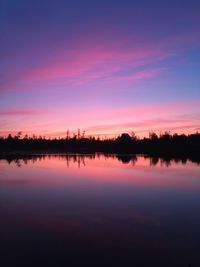 Scenic view of lake against romantic sky at sunset