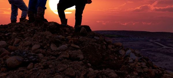 Low section of man walking on rock