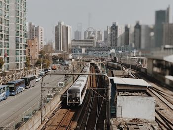 High angle view of railroad tracks in city against clear sky