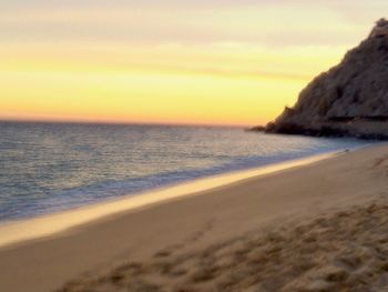 Scenic view of beach against sky during sunset