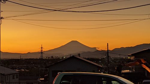 Aerial view of city against orange sky