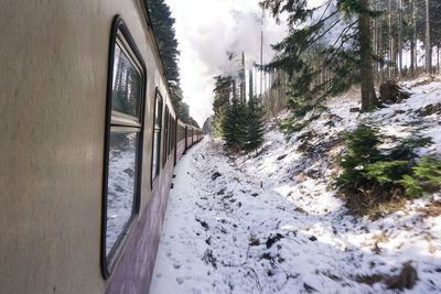 Close-up of train passing through snow covered landscape