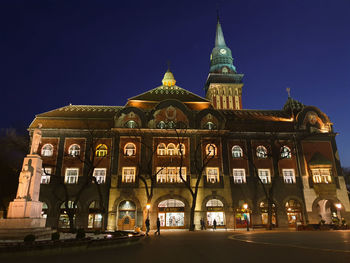 Low angle view of illuminated building against sky at night