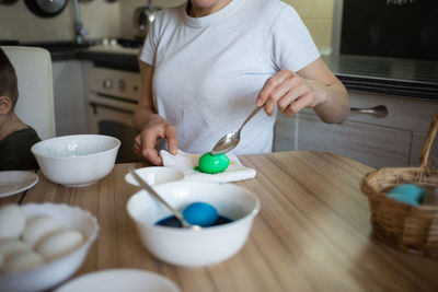 Midsection of woman having food on table