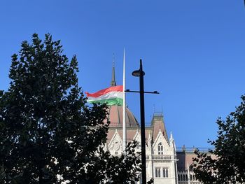 Low angle view of buildings against clear blue sky