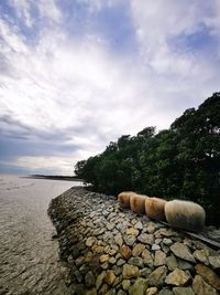 Rocks by sea against sky