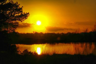 Scenic view of lake at sunset