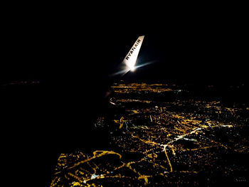 Aerial view of illuminated city against sky at night