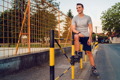 Young man with inline skates on road