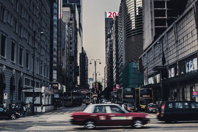 Cars on city street amidst buildings