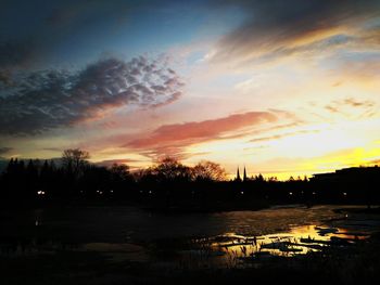Scenic view of lake against romantic sky at sunset