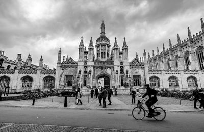 People riding bicycle on building