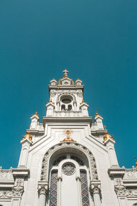 Low angle view of building against clear blue sky