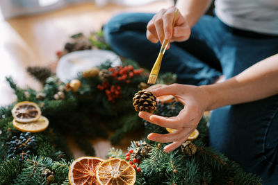 Midsection of woman holding christmas tree