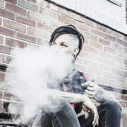 Portrait of young man sitting outdoors