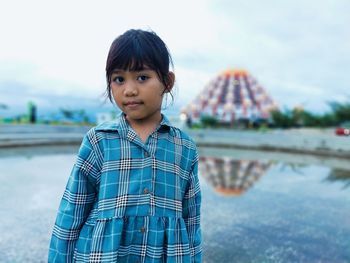 Portrait of cute girl standing in water