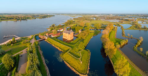 High angle view of city by sea against sky