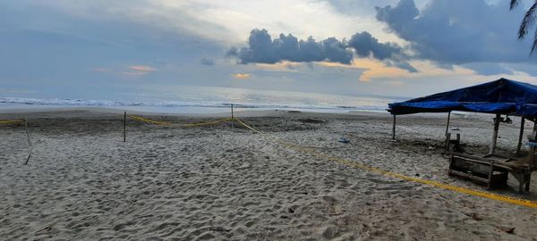 Scenic view of beach against sky during sunset