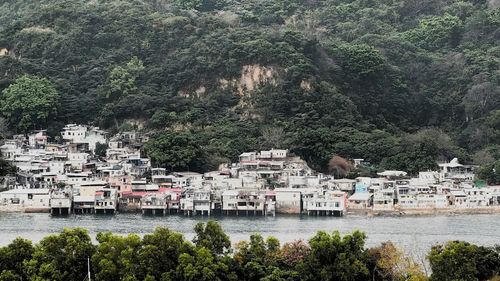 Scenic view of river by trees and mountains